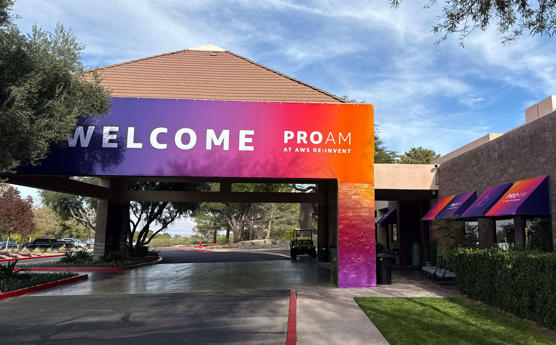 Gradient printed banner reading Welcome stretched across a resort porte-cochère